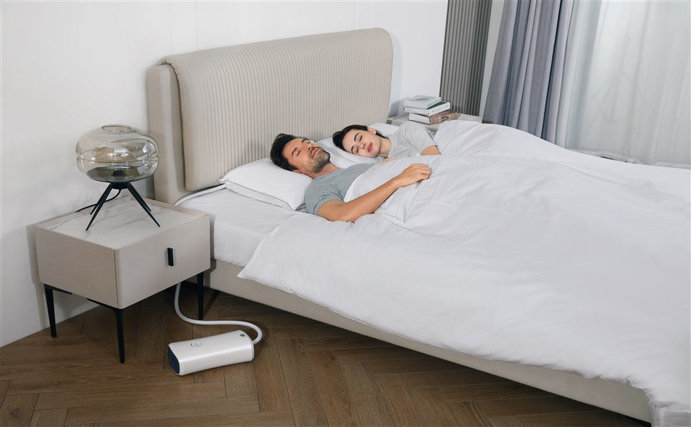 Couple sleeping with Nitetronic Z6 smart anti-snore pillow system