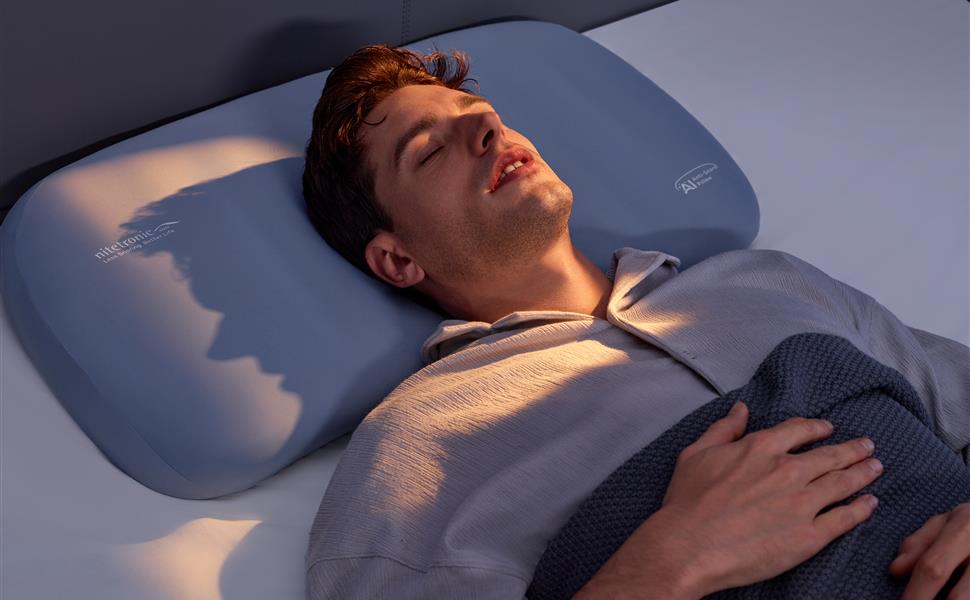 Back sleeper resting on the Nitetronic A1 smart anti-snore pillow in a nighttime bedroom
