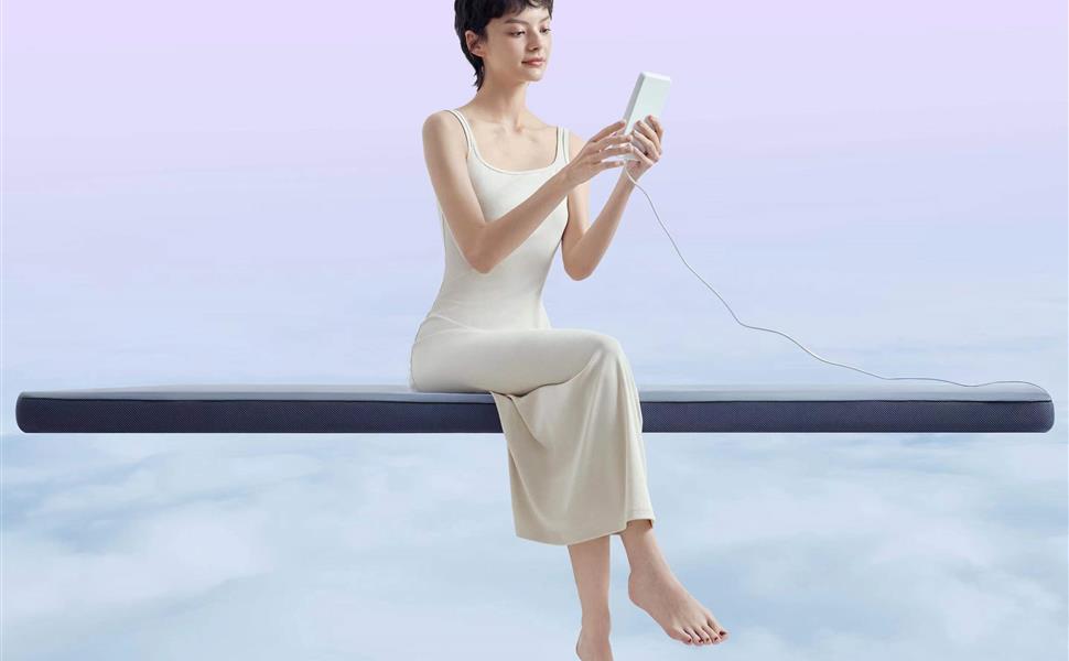 Person using the controller while seated on the Nitetronic G1 smart massage mattress pad