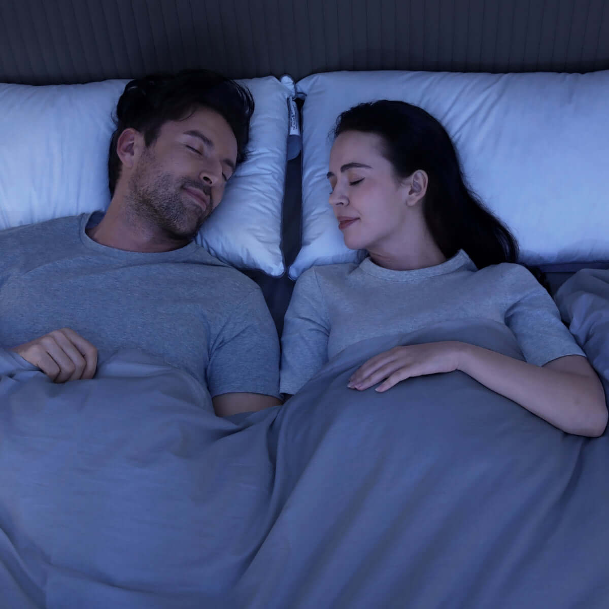 Couple sleeping peacefully using anti-snoring pillows for restful sleep, highlighting pillow effectiveness in reducing snoring.