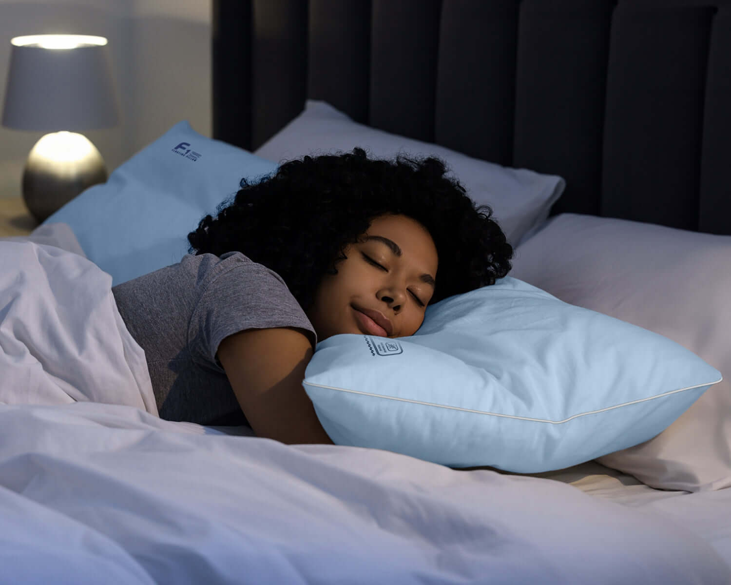 Woman sleeping comfortably on a Nitetronic F1 Floating Pillow, ideal for hot sleepers seeking ultimate cooling and restful sleep.