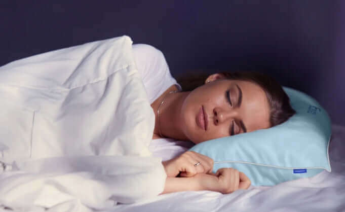 A person peacefully sleeping on a Nitetronic F1 Floating Pillow, highlighting comfort and innovation for the 2024 Paris Olympics.