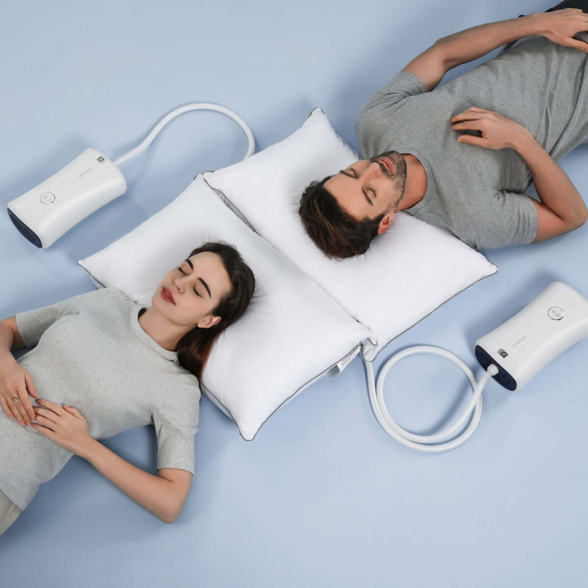 Couple using Nitetronic anti-snore pillows, demonstrating effective snoring solution with advanced sleep technology.