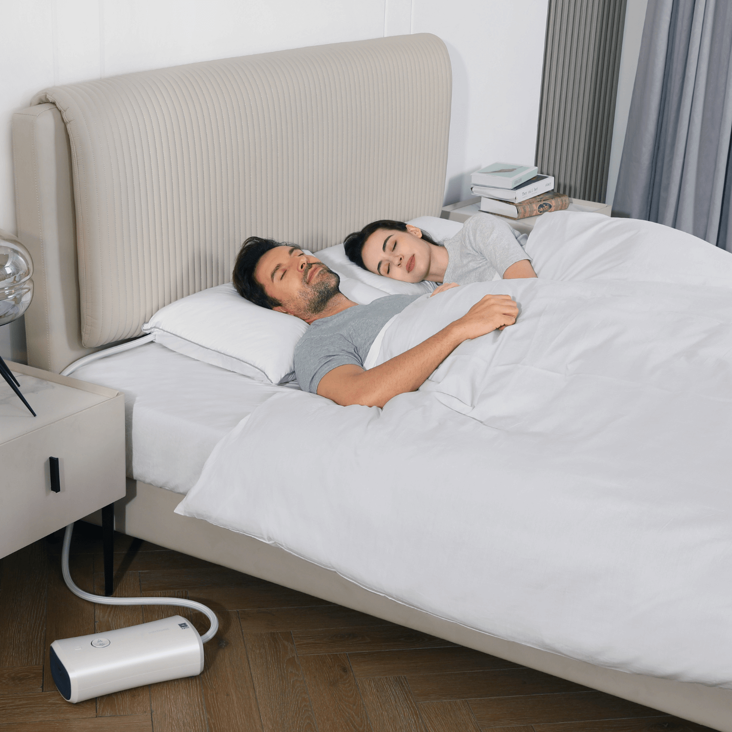 Couple sleeping peacefully with Nitetronic Z6 anti-snoring device on bedside for snore-free night.
