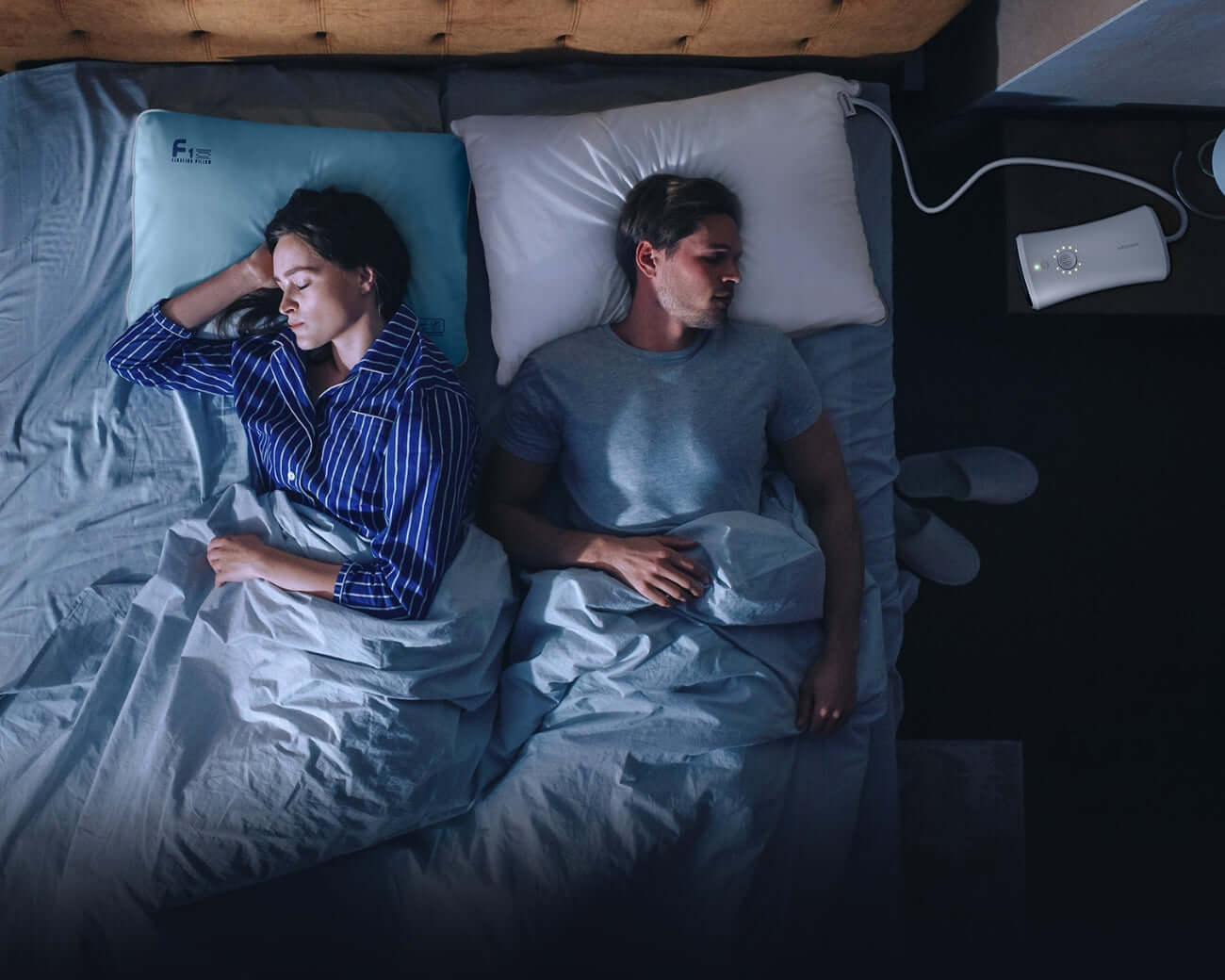 Couple sleeping soundly with a Nitetronic CPAP pillow to alleviate sleep apnea symptoms.