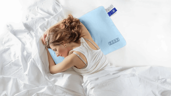 Woman sleeping on Nitetronic F1 Floating Pillow, a nontoxic sleep solution for 2024 prioritizing health and comfort.