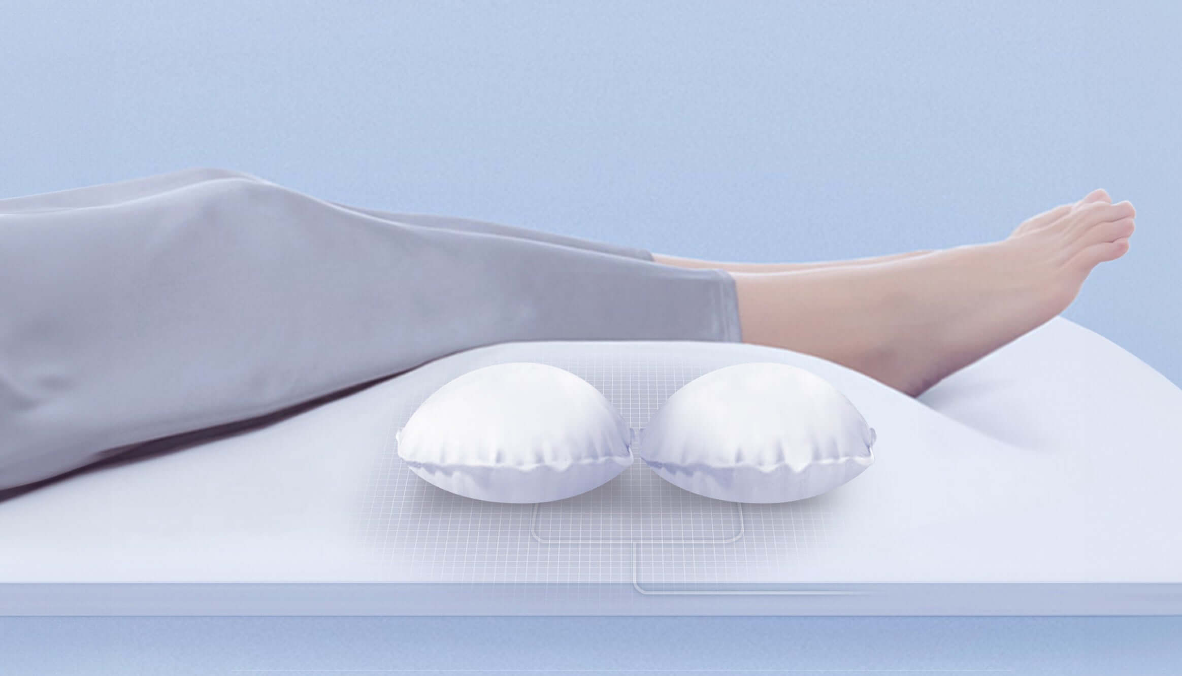 Legs resting on a mattress with ergonomic support pillows, promoting comfort and spinal alignment.