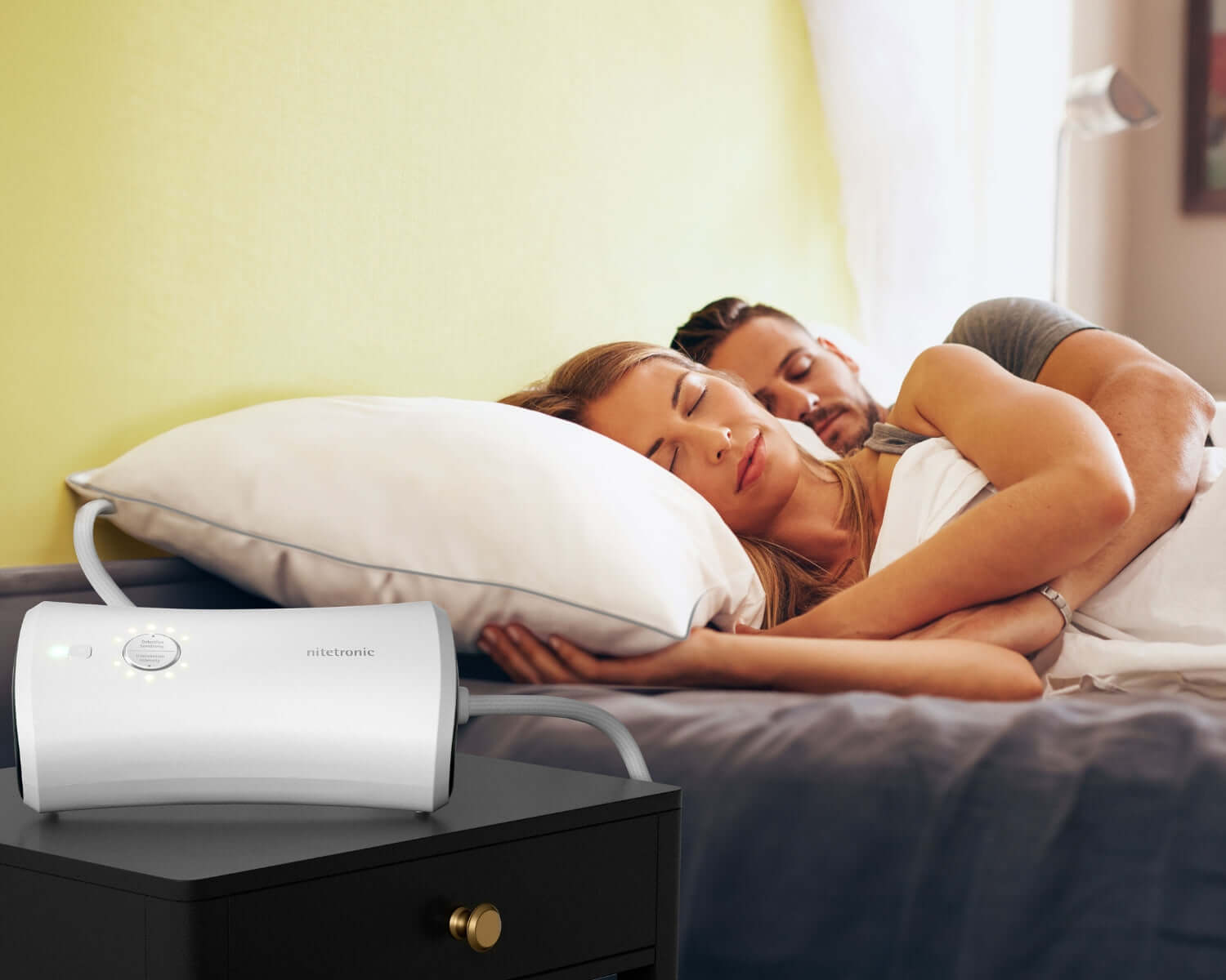 Couple sleeping comfortably with Nitetronic Z6 CPAP pillow on bedside, showcasing snoring therapy solution.