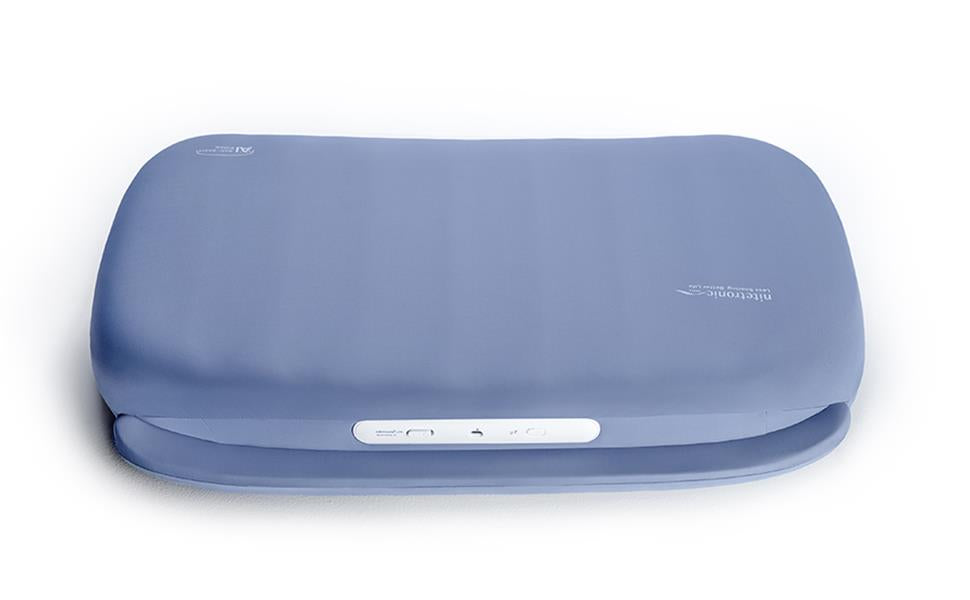 Nitetronic A1 smart anti-snore pillow showing its shaped blue cover and control panel