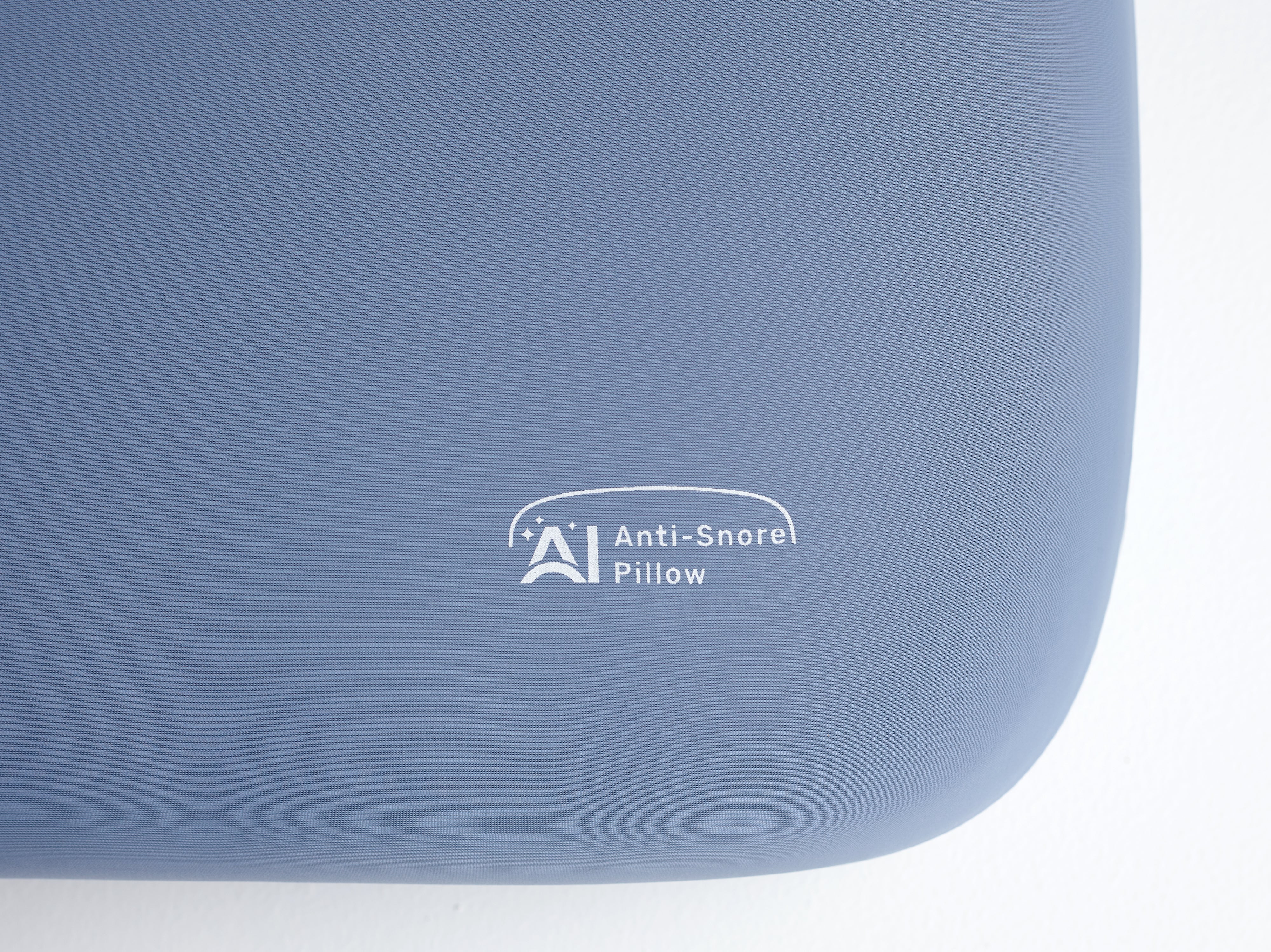 Nitetronic A1 AI Anti-Snore Pillow with ergonomic design for snoring reduction, blue surface showcasing embroidered logo.